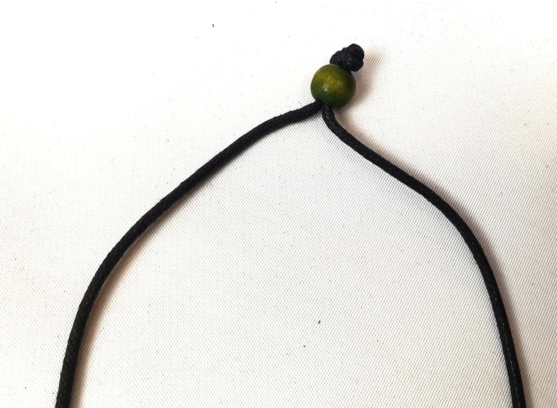 Rare Rabbit non-leather black necklace with green wooden leaf